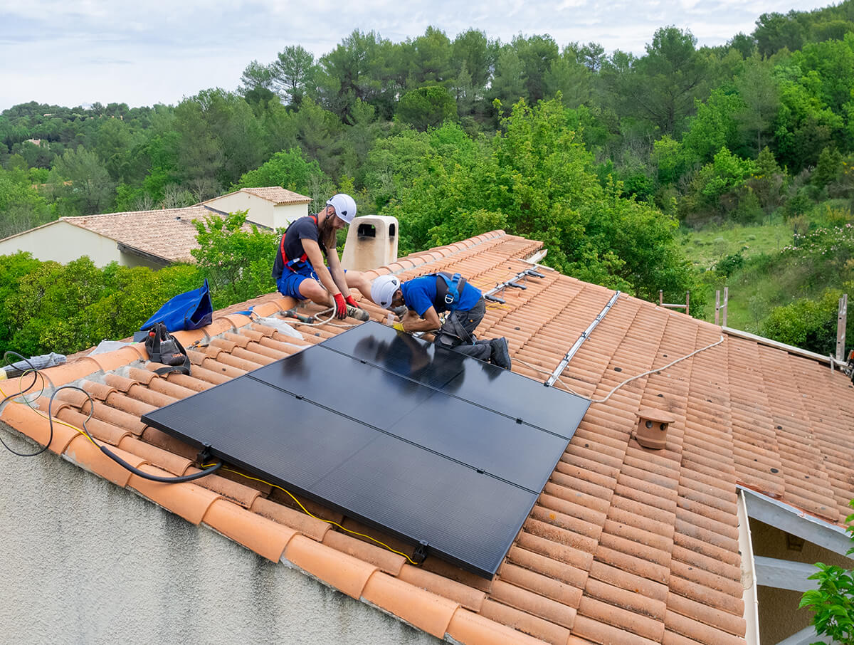 deux-installateurs-panneaux-solaires-photovoltaiques-toiture-tuiles-maison